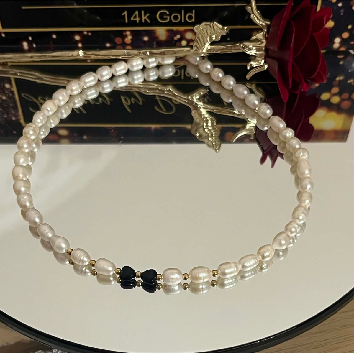 Black bow pearl necklace